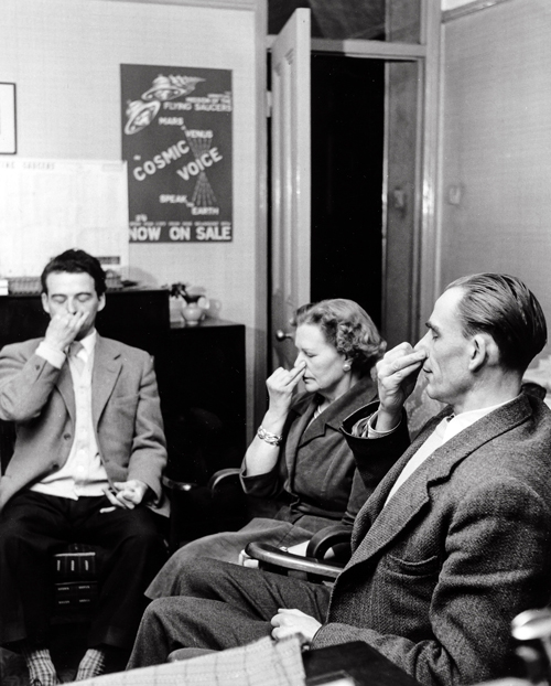 Dr. King and others performing yoga breathing exercises.