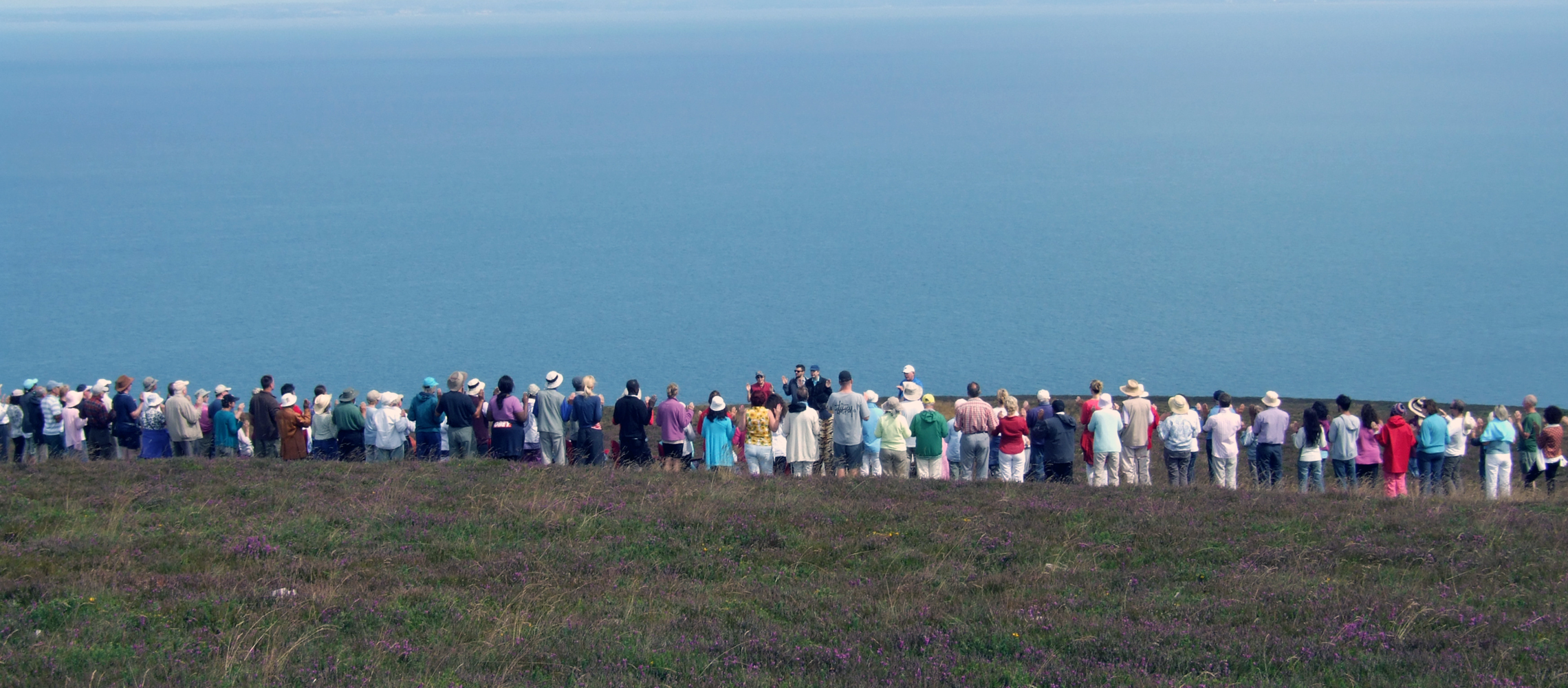 line-of-people-holdstone-down_website