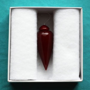 Radionic pendulum with a red lacquer